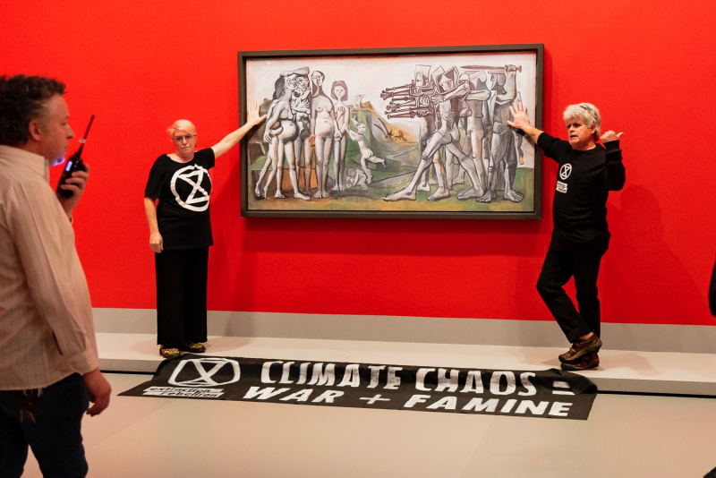 Australian protesters glue hands to cover of Picasso painting