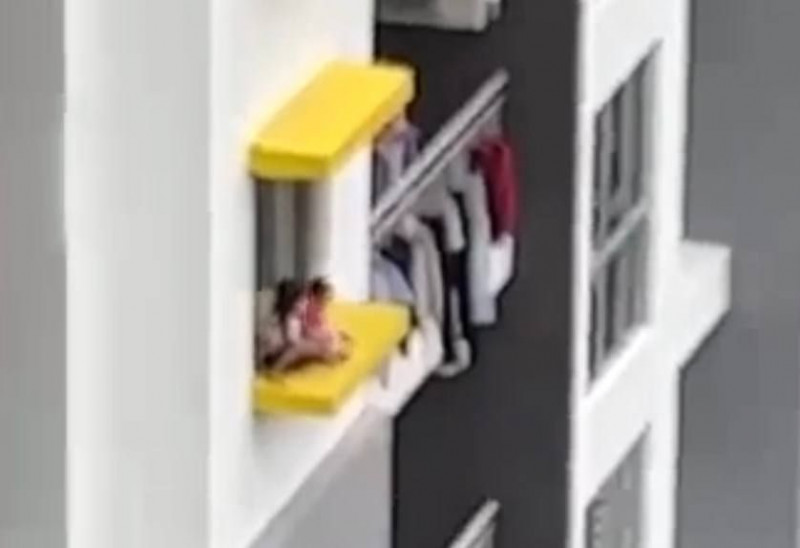 Police probe into parents over clip of kids playing on window ledge