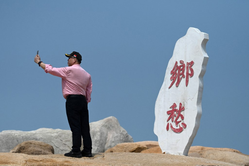 Unfazed Chinese tourists soak up sun amid military drills over Taiwan
