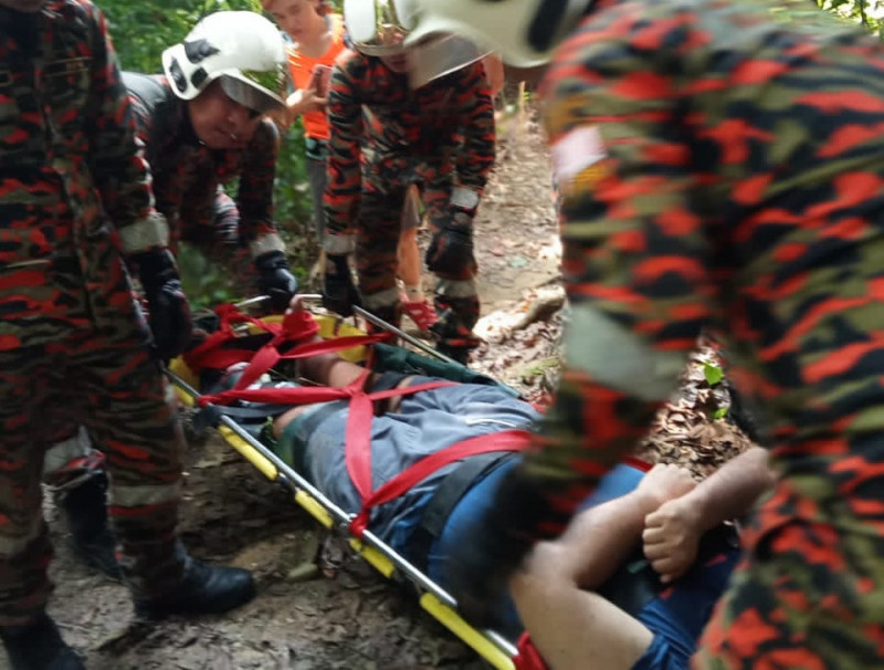 Firefighters toil to stretcher stranded hiker from hill in Manjung
