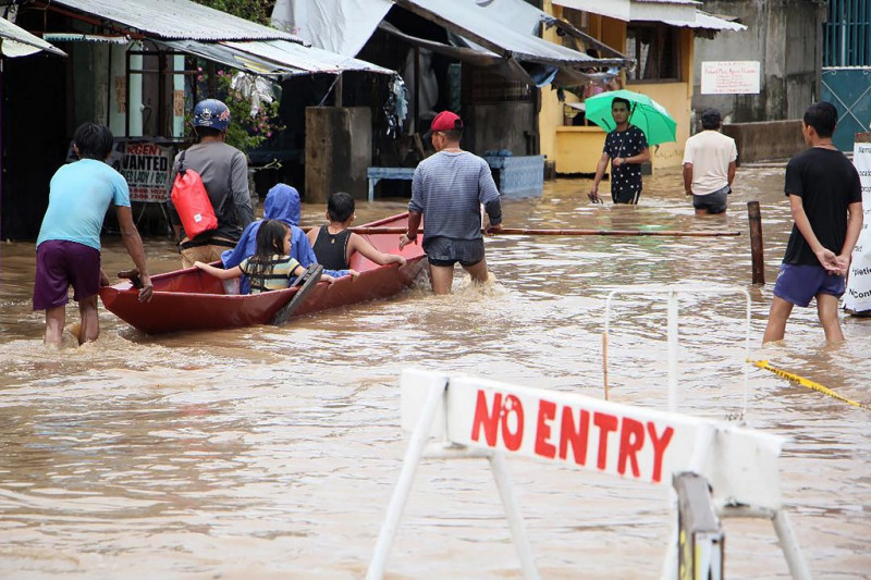 Eight dead in Philippine floods as thousands flee homes