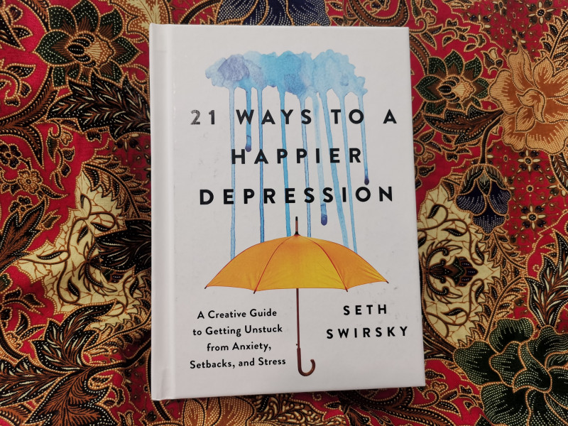 Light reads: '21 Ways to a Happier Depression'