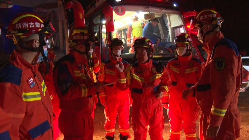 China mine collapse: landslide holds up search for survivors