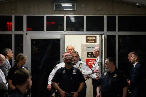 With hunched shoulders and pursed lips, Trump plays defence