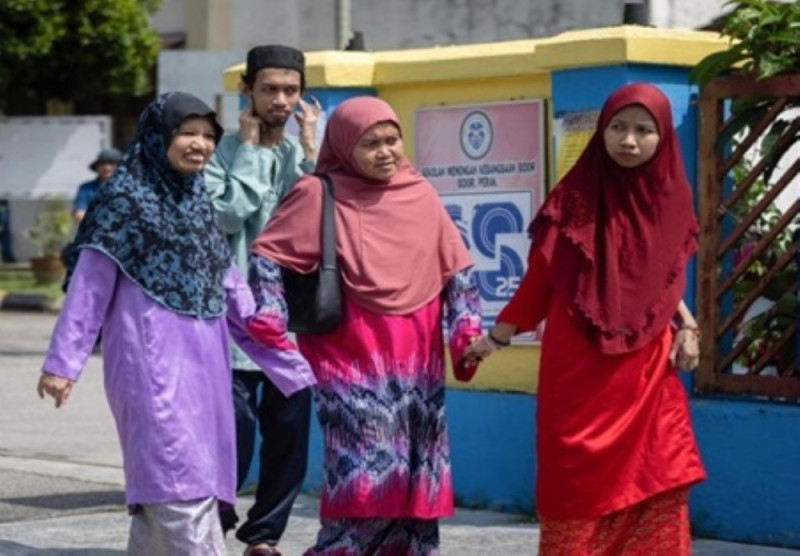 Single mother ensures autistic children cast their votes in Ayer Kuning By-Election