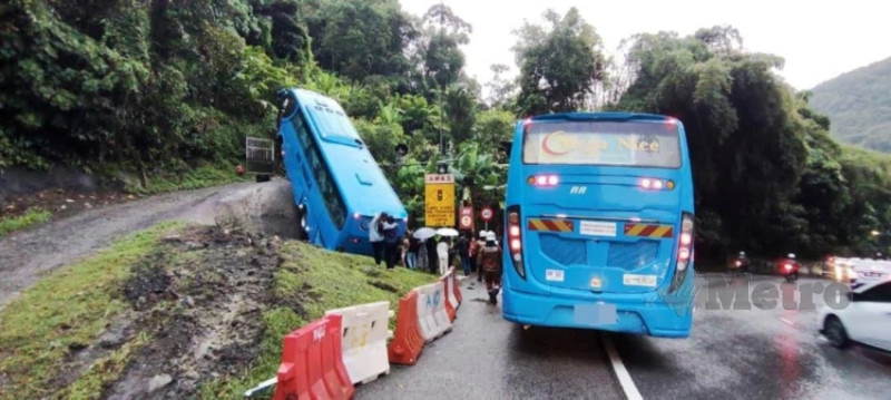 Four Injured as factory bus crashes on hilly bend in Penang