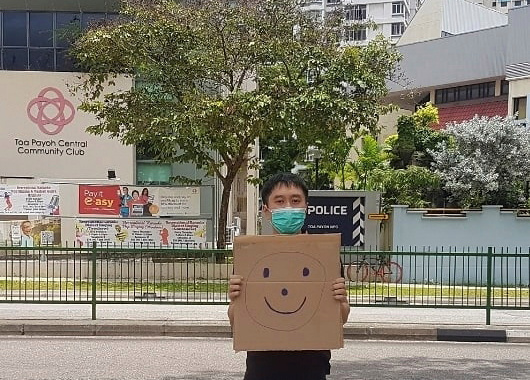 S’pore activist charged over one-man smiley face protest