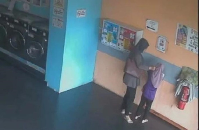 Woman held over alleged assault on daughter at laundromat