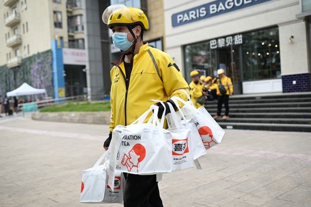 China tells delivery, ride-hailing firms to better protect workers