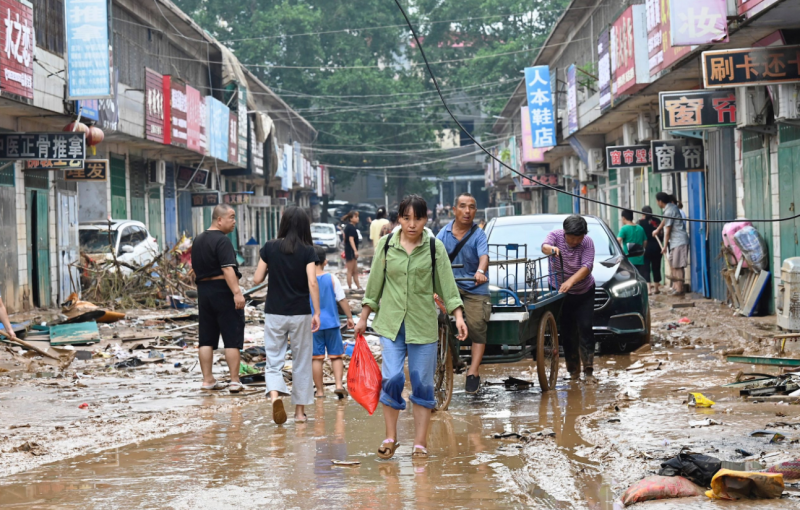 Chinese city picks through debris after record rains kill 33