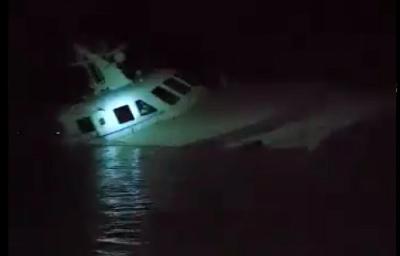 Slowly sinking ferry piques curiosity at Kuah jetty