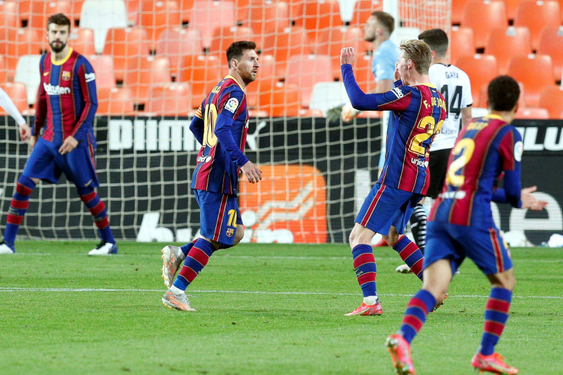 Messi double leads Barca to nail-biting win over Valencia