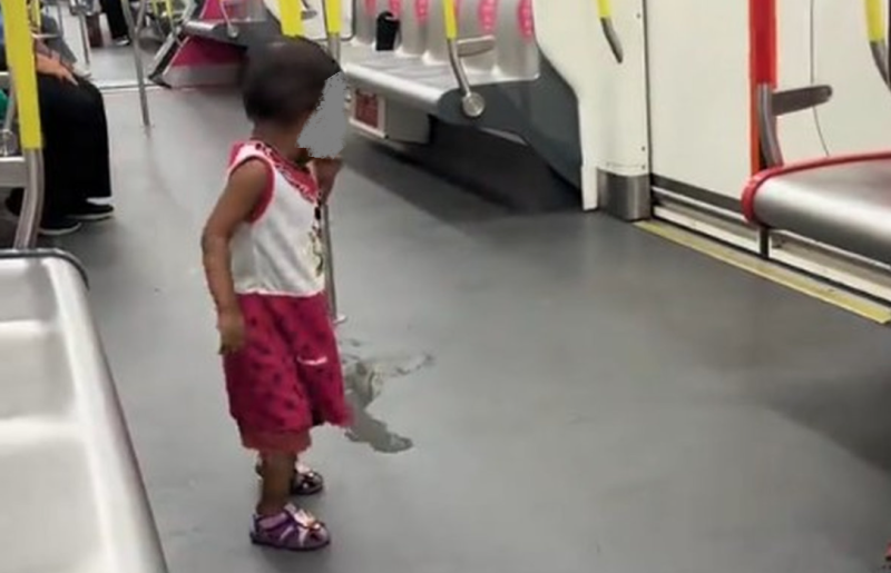 Netizens outraged as child urinates in LRT, mum busy on handphone