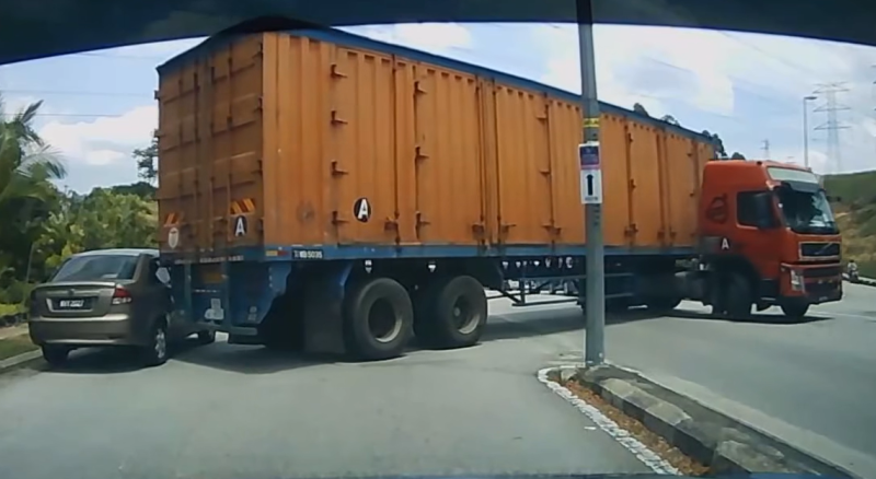 Trailer driver makes illegal U-turn, crashes into car parked on road shoulder